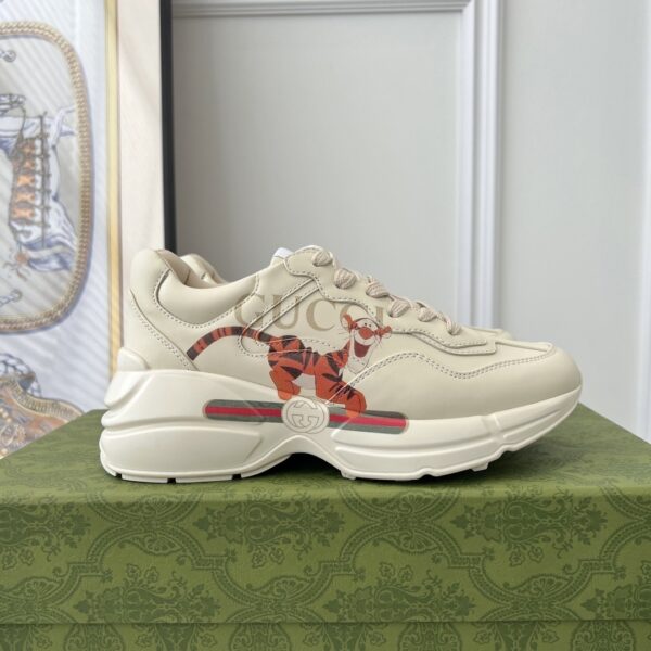 sy_no_3B6147E7F520C3673A90A8324575F077_0 Gucci x Disney Rhyton “Tigger” Sneaker in Off-White