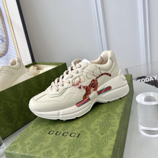 sy_no_3B6147E7F520C3673A90A8324575F077_1 Gucci x Disney Rhyton “Tigger” Sneaker in Off-White