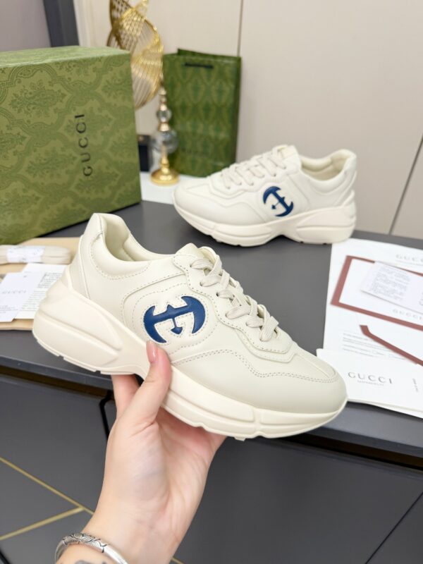 sy_no_61C110CC52F69EBD6044D3BF0BF10672_0 Gucci Rhyton Leather Sneaker in Off-White with Blue Interlocking G Logo
