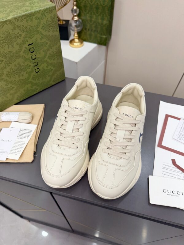 sy_no_61C110CC52F69EBD6044D3BF0BF10672_2 Gucci Rhyton Leather Sneaker in Off-White with Blue Interlocking G Logo