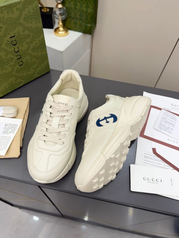 sy_no_61C110CC52F69EBD6044D3BF0BF10672_3 Gucci Rhyton Leather Sneaker in Off-White with Blue Interlocking G Logo