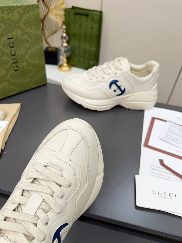 sy_no_61C110CC52F69EBD6044D3BF0BF10672_5 Gucci Rhyton Leather Sneaker in Off-White with Blue Interlocking G Logo
