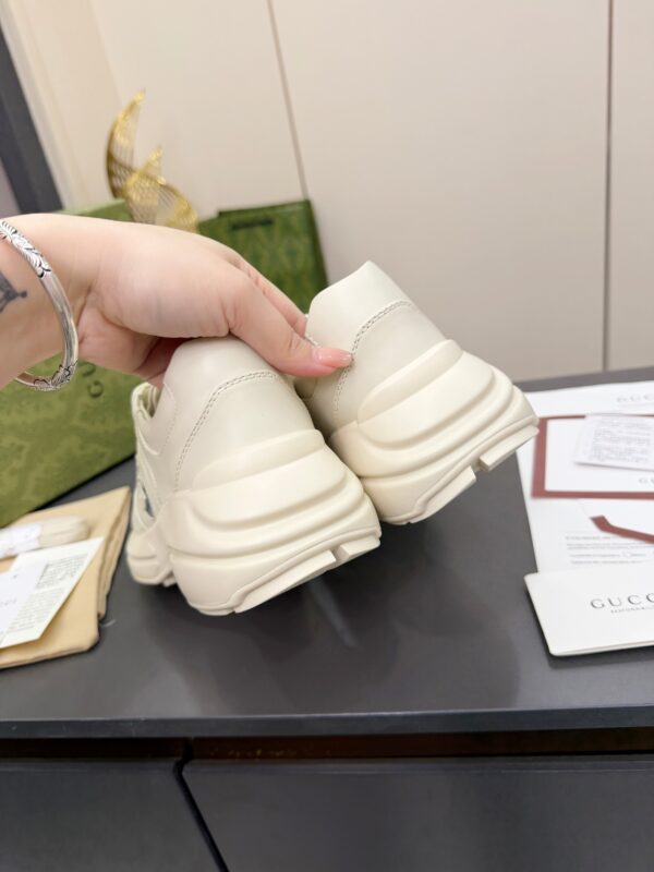 sy_no_61C110CC52F69EBD6044D3BF0BF10672_6 Gucci Rhyton Leather Sneaker in Off-White with Blue Interlocking G Logo