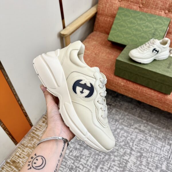 sy_no_7F5815E2E4EB510AFD17E649CF16BE46_1 Gucci Rhyton Leather Sneaker in Off-White with Black Interlocking G Logo