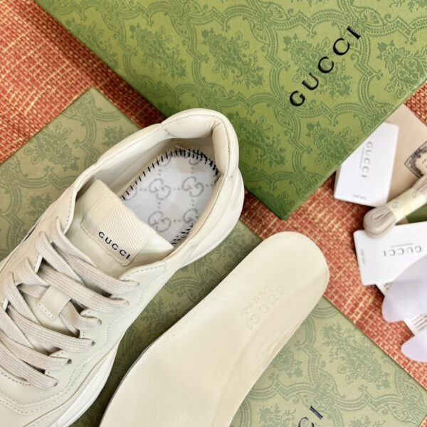 sy_no_7F5815E2E4EB510AFD17E649CF16BE46_6 Gucci Rhyton Leather Sneaker in Off-White with Black Interlocking G Logo