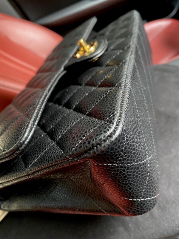 sy_no_BA3037C3101F840EB2D3087C853D4CA8_3 Chanel Classic CF 1112 shoulder bag featuring a chain strap and lock closure, crafted from premium imported caviar-grained calfskin.