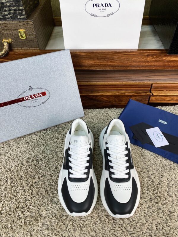 sy_no_10BE1484FA39D03407E0AA139E9EA24F_0 Prada Black White Leather Triangle Chunky Sneaker