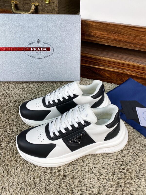 sy_no_10BE1484FA39D03407E0AA139E9EA24F_1 Prada Black White Leather Triangle Chunky Sneaker