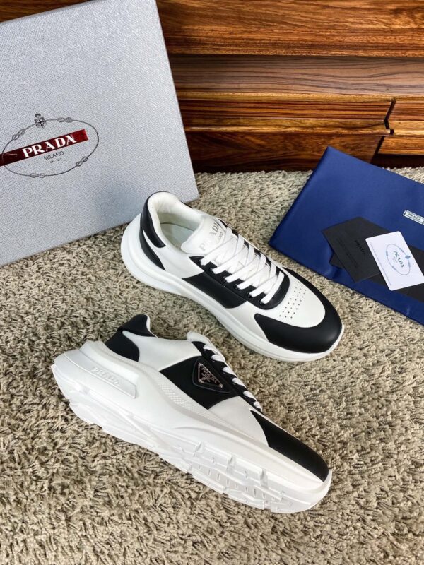 sy_no_10BE1484FA39D03407E0AA139E9EA24F_2 Prada Black White Leather Triangle Chunky Sneaker