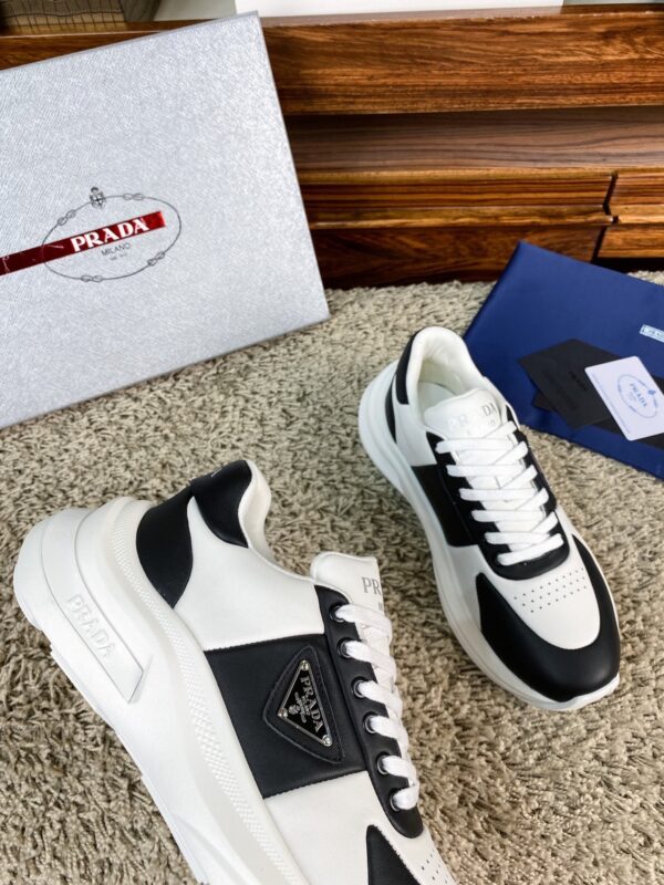 sy_no_10BE1484FA39D03407E0AA139E9EA24F_4 Prada Black White Leather Triangle Chunky Sneaker