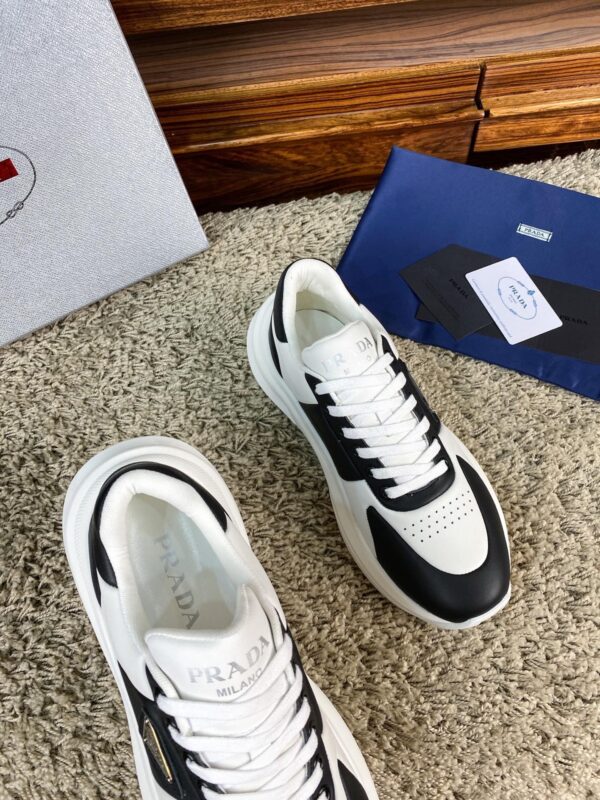 sy_no_10BE1484FA39D03407E0AA139E9EA24F_5 Prada Black White Leather Triangle Chunky Sneaker