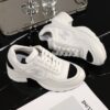 Chanel White and Black Leather Low-Top Sneaker with Cap-Toe and CC Logo