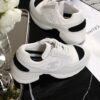 Chanel White and Black Leather Low-Top Sneaker with Cap-Toe and CC Logo