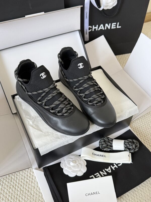 sy_no_301C920624F03E29F93F7AC768B3CE56_0 Chanel Black Leather and Knit Slip-On Low-Top Sneaker with Speckled Laces and CC Logo