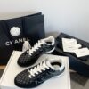 Chanel Black Quilted Leather Low-Top Sneaker with White Laces and CC Logo
