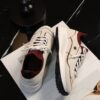 sy_no_560C0E2DD154136B20A24989179C93C6_1 Chanel Off-White and Burgundy Mixed Material Low-Top Sneaker with Contrast Piping and CC Logo