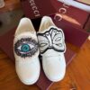 sy_no_5DE36B953E19D4D130FF8C8A0A3E6048_0 Gucci White Leather Low-Top Sneaker with Embroidered Eye and Bow Flaps