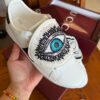 sy_no_5DE36B953E19D4D130FF8C8A0A3E6048_1 Gucci White Leather Low-Top Sneaker with Embroidered Eye and Bow Flaps