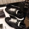 sy_no_7281AD9259070FB5D9F5F654A2AB23D1_2 Chanel Black and White Leather Low-Top Sneaker with Suede Toe Cap and CC Logo