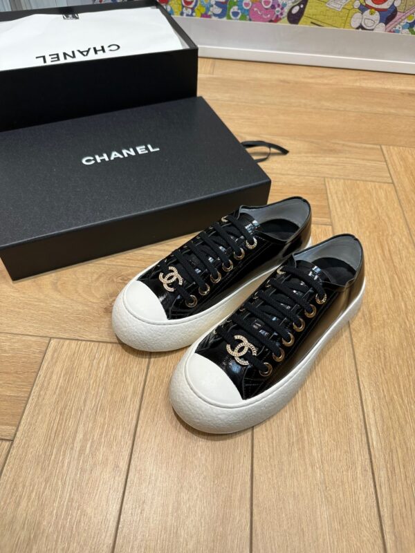 sy_no_751A43FAB37A52E3218B306140ED62C1_0 Chanel Black-White Patent-Leather Low-Top Sneaker with Gold-Tone CC Logo