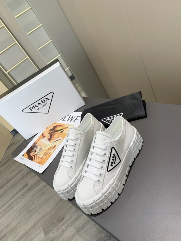 sy_no_878C2928CDBA44C004805BC79FF023A1_1 Prada White Canvas Black-Trim Triangle Tread Platform Sneaker
