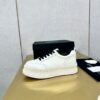 sy_no_89259C145494347802A26325E75A0481_0 Chanel Off-White Leather Platform Low-Top Sneaker with Black Laces and Ribbed Sole