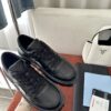 Prada All-Black Leather Metal Triangle Platform Sneaker