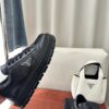 Prada All-Black Leather Metal Triangle Platform Sneaker