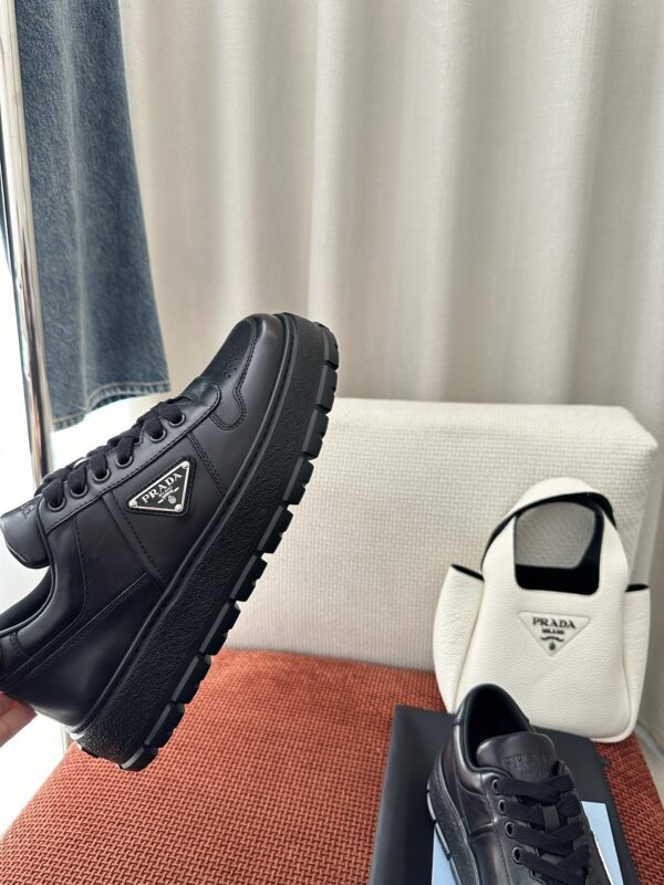 Prada All-Black Leather Metal Triangle Platform Sneaker