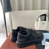 Prada All-Black Leather Metal Triangle Platform Sneaker