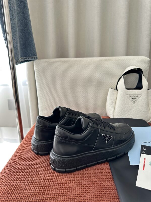 Prada All-Black Leather Metal Triangle Platform Sneaker