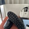 Prada All-Black Leather Metal Triangle Platform Sneaker