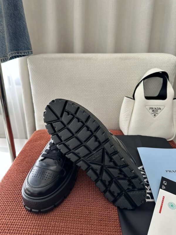 Prada All-Black Leather Metal Triangle Platform Sneaker