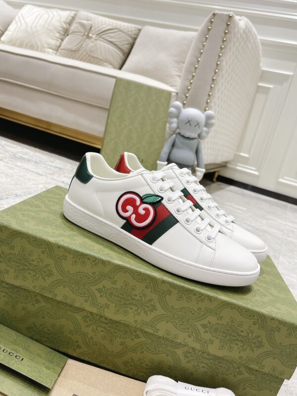 sy_no_A919EE0AC10E68ED0E33DB7D6F6A55BB_0 Gucci White Leather Low-Top Sneaker with Apple Interlocking G and Web Stripe