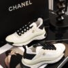 sy_no_BCB44C72A0CBB640D9AFA7D630A9F012_1 Chanel White and Black Mixed Material Low-Top Sneaker with Gold Hardware CC Logo