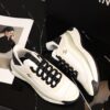 sy_no_BCB44C72A0CBB640D9AFA7D630A9F012_4 Chanel White and Black Mixed Material Low-Top Sneaker with Gold Hardware CC Logo
