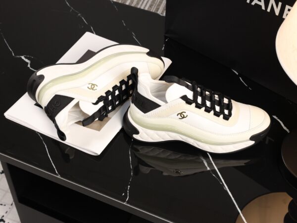 sy_no_BCB44C72A0CBB640D9AFA7D630A9F012_6 Chanel White and Black Mixed Material Low-Top Sneaker with Gold Hardware CC Logo