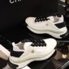 sy_no_BCB44C72A0CBB640D9AFA7D630A9F012_7 Chanel White and Black Mixed Material Low-Top Sneaker with Gold Hardware CC Logo