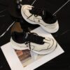 Chanel Off-White and Black Mixed Material Low-Top Sneaker with Contrast Piping and CC Logo