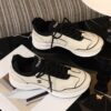 Chanel Off-White and Black Mixed Material Low-Top Sneaker with Contrast Piping and CC Logo