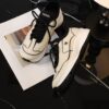 Chanel Off-White and Black Mixed Material Low-Top Sneaker with Contrast Piping and CC Logo