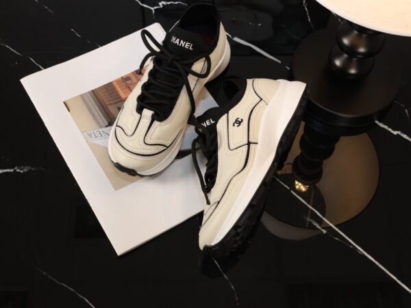 Chanel Off-White and Black Mixed Material Low-Top Sneaker with Contrast Piping and CC Logo