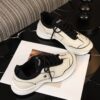 Chanel Off-White and Black Mixed Material Low-Top Sneaker with Contrast Piping and CC Logo