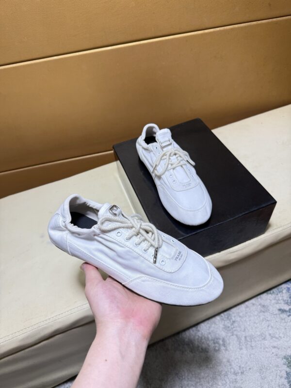 sy_no_C5B5DA905A6FC77396342367800B25DD_0 Prada Off-White Gathered Nylon Retro Trainer