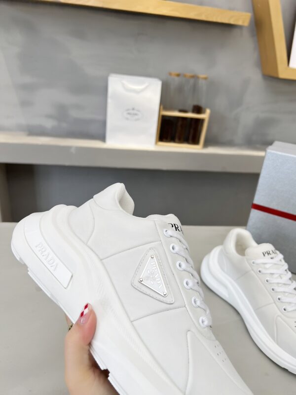 sy_no_E0D5A4917EB9C87270711D75751964BC_1 Prada White Triangle Logo Platform Sneaker