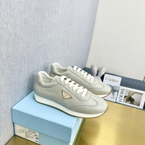 sy_no_E249A52934DC712A867AFA5CEC3A2A41_0 Prada Light Grey Pebbled Leather Retro Runner