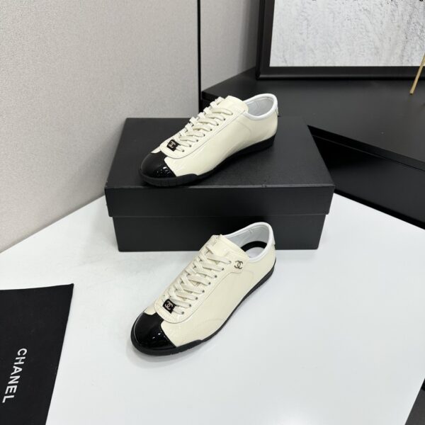 sy_no_EBE9D714E87BFE3714AEF0457AC9E1B2_1 Chanel Off-White and Black Patent Cap-Toe Low-Top Sneaker with CC Lace Lock