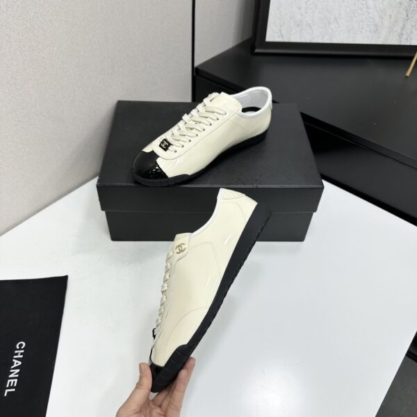 sy_no_EBE9D714E87BFE3714AEF0457AC9E1B2_2 Chanel Off-White and Black Patent Cap-Toe Low-Top Sneaker with CC Lace Lock