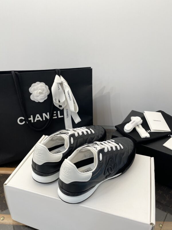 Chanel Black Quilted Leather Low-Top Sneaker with White Laces and CC Logo